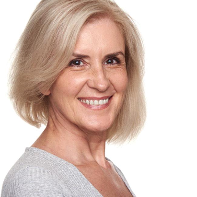 Confident older woman smiling with her All-on-4 denture