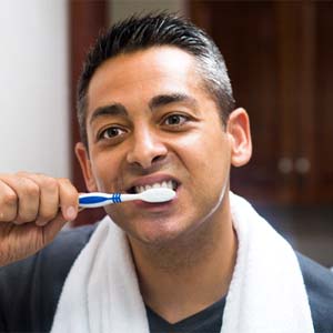 man brushing his teeth