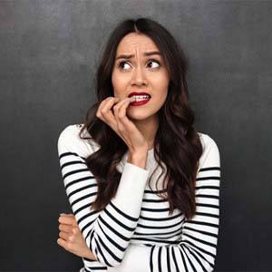 woman nervously biting her fingernails