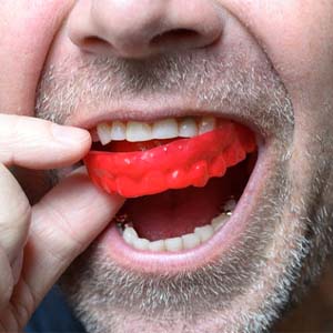man wearing a red mouthguard