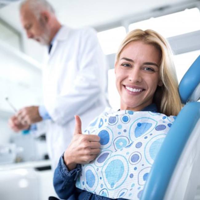 Woman touching question mark, ready for answers to questions about dental implants