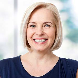 Smiling woman with dental implants in Los Angeles