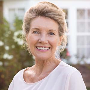 Woman smiling with dental implants in Los Angeles